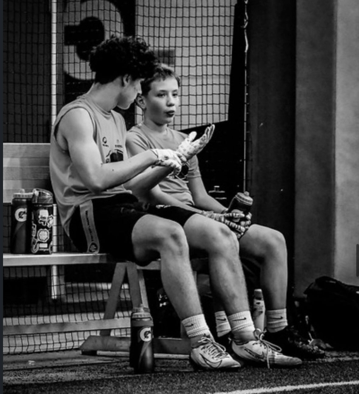 Two Eagles athletes talking on the bench during a game