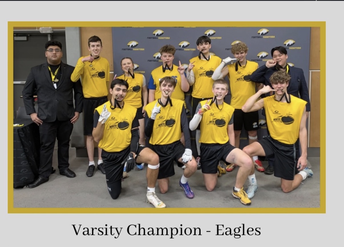 Eagles varsity team posing with Football Manitoba medals